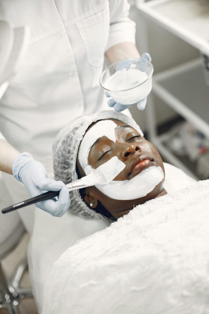 Woman receiving a calming facial mask in a professional spa environment.